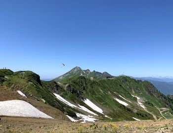 Scenic view of mountains against clear blue sky