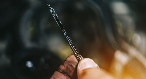 Close-up of person holding stick