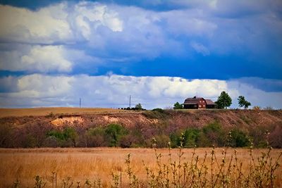 Scenic view of field against cloudy sky