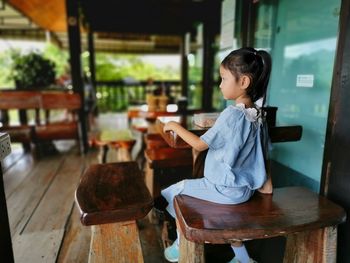 Girl sitting on table