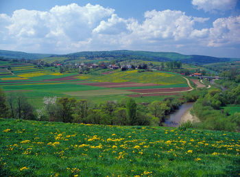 View of countryside landscape against cloudy sky