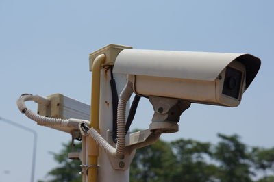 Low angle view of camera against clear sky