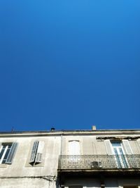 Low angle view of building against clear blue sky