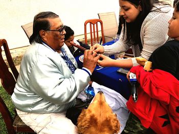 Rear view of people standing outdoors