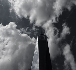 Low angle view of modern building against cloudy sky