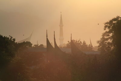 Panoramic view of buildings against sky during sunset