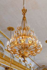 Low angle view of illuminated chandelier hanging in building