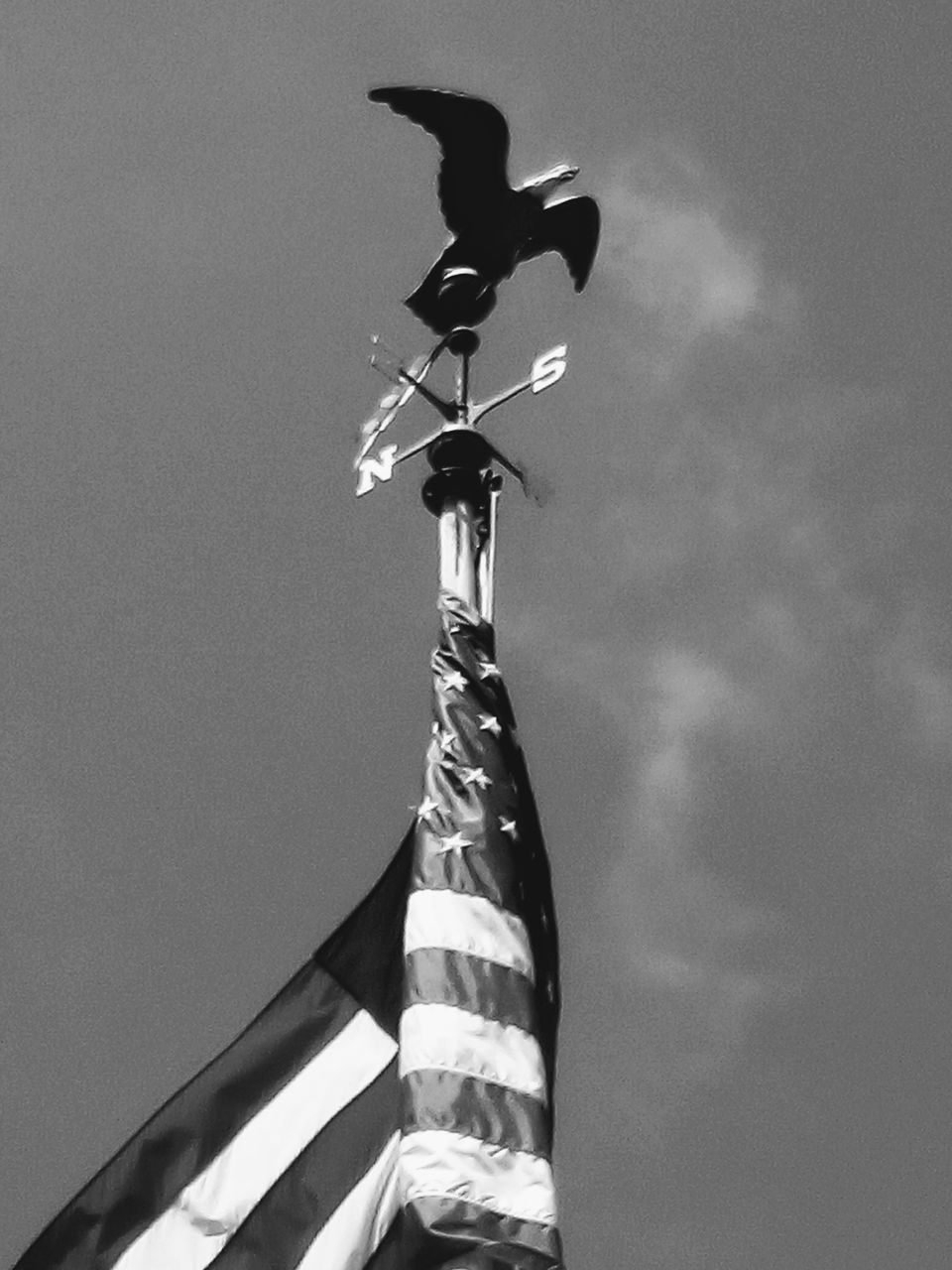 LOW ANGLE VIEW OF WEATHER VANE AGAINST CLOUDS