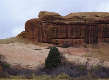 Rock formations on landscape against sky