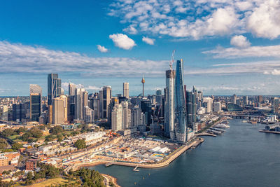 Aerial view modern skyscrapers and buildings near ocean and cloudy sky. sydney, australia.