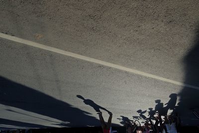 Shadow of people on road