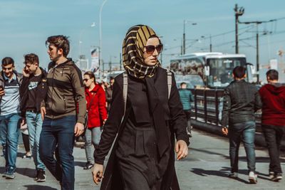 People standing in front of a city
