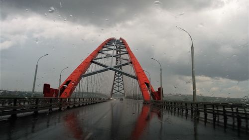 Wet bridge against sky during rainy season