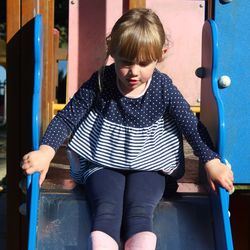 Cute girl sitting on slide