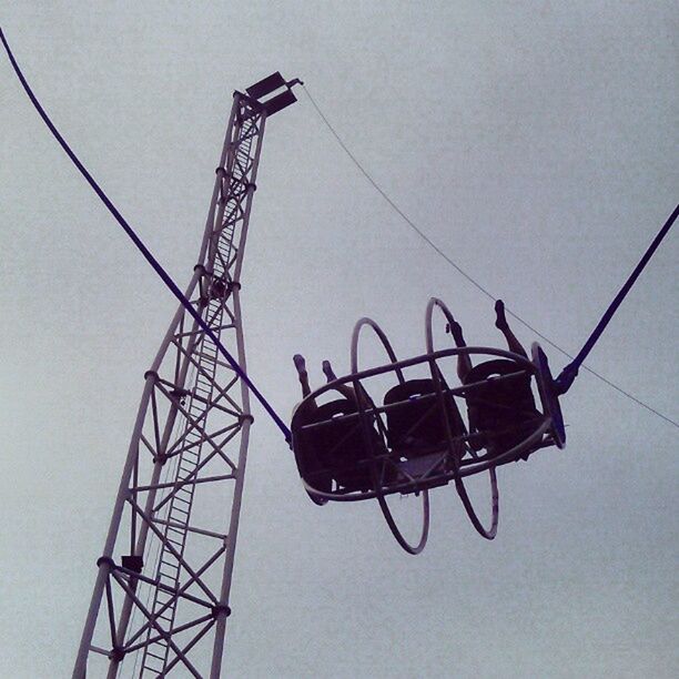 low angle view, electricity, clear sky, technology, power line, power supply, connection, electricity pylon, cable, fuel and power generation, built structure, sky, day, metal, outdoors, no people, construction site, architecture, silhouette, lighting equipment