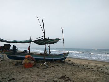 Deck chairs on beach against clear sky