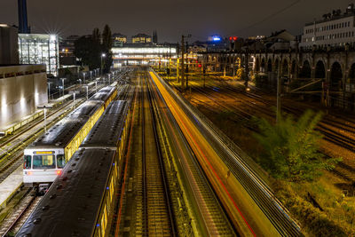High angle view of trains on railroad tracks at night