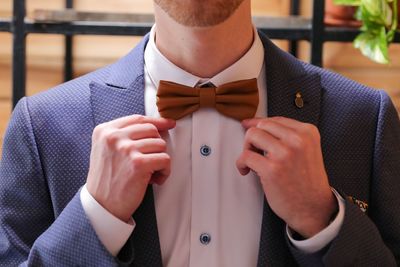 Midsection of man wearing bow tie