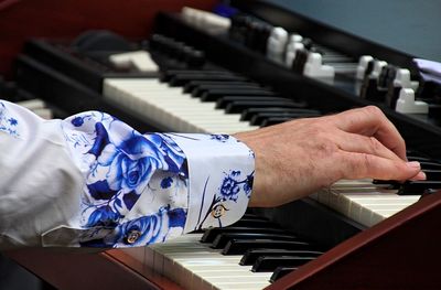 Close-up of hands playing piano