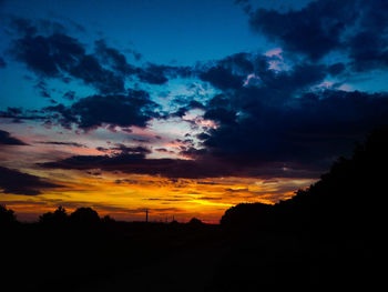 Scenic view of silhouette landscape against sky at sunset