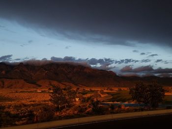 Scenic view of mountains against cloudy sky