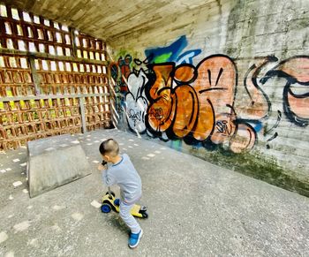 Full length of boy playing on wall