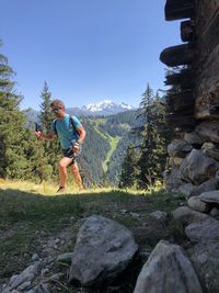 Man on rock against sky