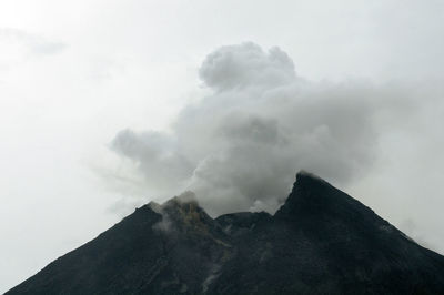 Clouds over mountains against sky