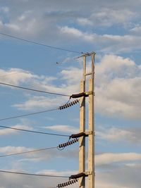 Low angle view of crane against sky