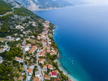 High angle view of townscape by sea