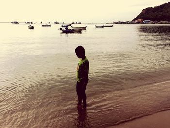 Rear view of man standing on beach