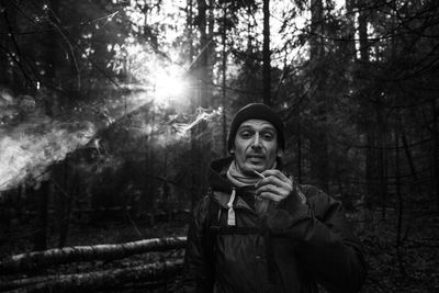 Portrait of man smoking in forest