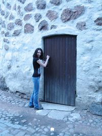 Portrait of young woman knocking door