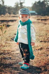 Portrait of cute girl standing on field