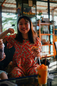 Portrait of young woman sitting in cafe