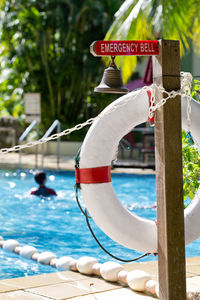 Close-up of emergency sign at poolside