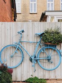 Bicycle with decor against wall of building