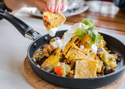 Close-up of hand holding food on table