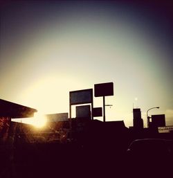 Low angle view of buildings against sky at sunset