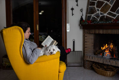 Portrait of woman with dog at home