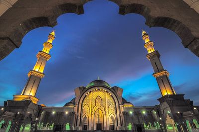 Low angle view of illuminated buildings against sky