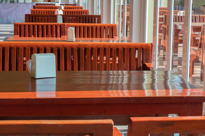 Empty chairs and tables in cafe against building