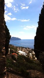 High angle view of townscape by sea against sky