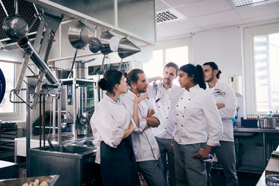 Chefs communicating in commercial kitchen