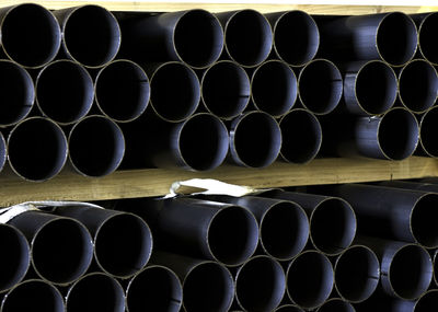 Full frame shot of stack of pipes