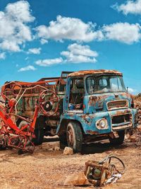 Abandoned car against sky