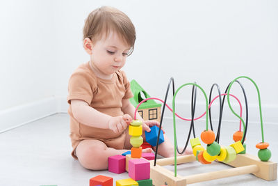 Baby girl playing with toy at home