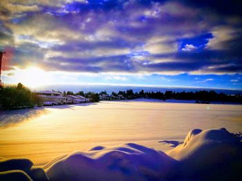Scenic view of river against sky during sunset