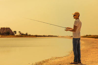 Full length of man standing on lake