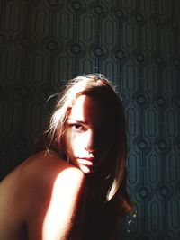 Side view portrait of shirtless woman at home